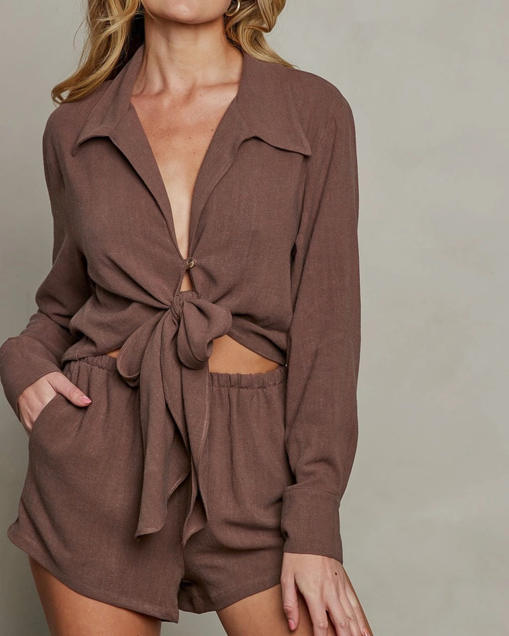 Brown linen pull-on shorts with stretch waistband and side pockets, styled casually.