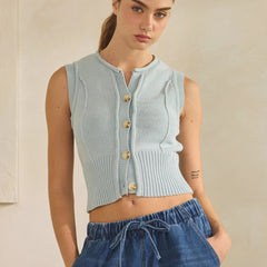 Woman wearing a light blue sleeveless button down knit tank top 