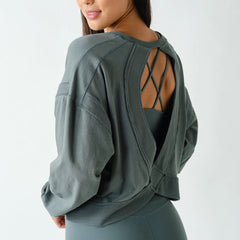 Women's oversized eucalyptus green Pima cotton open back long sleeve tee with relaxed fit, cutout back detail, ribbed trim, and drop shoulders.