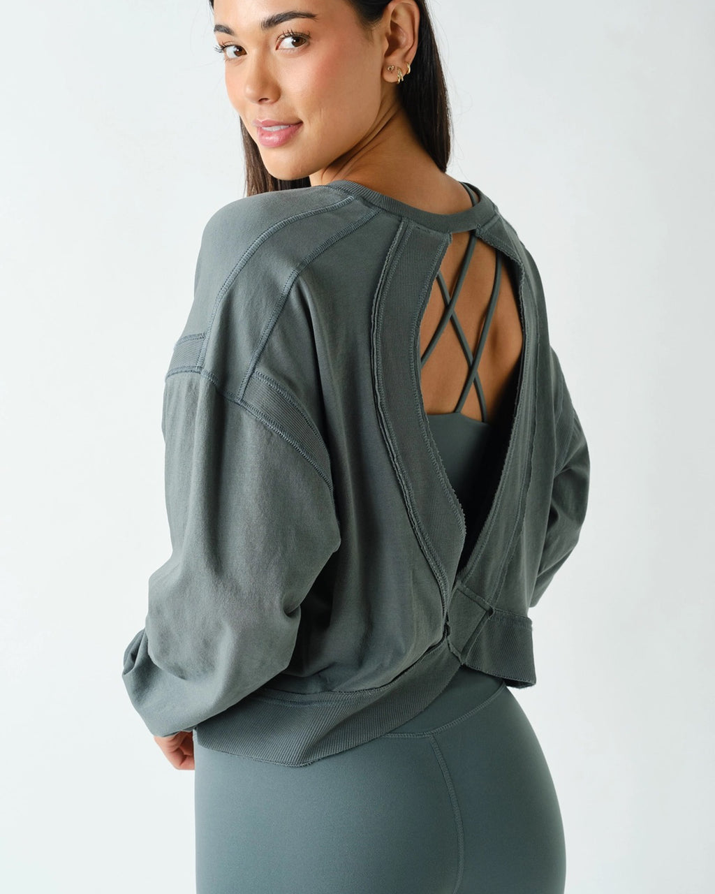 Women's oversized eucalyptus green Pima cotton open back long sleeve tee with relaxed fit, cutout back detail, ribbed trim, and drop shoulders.