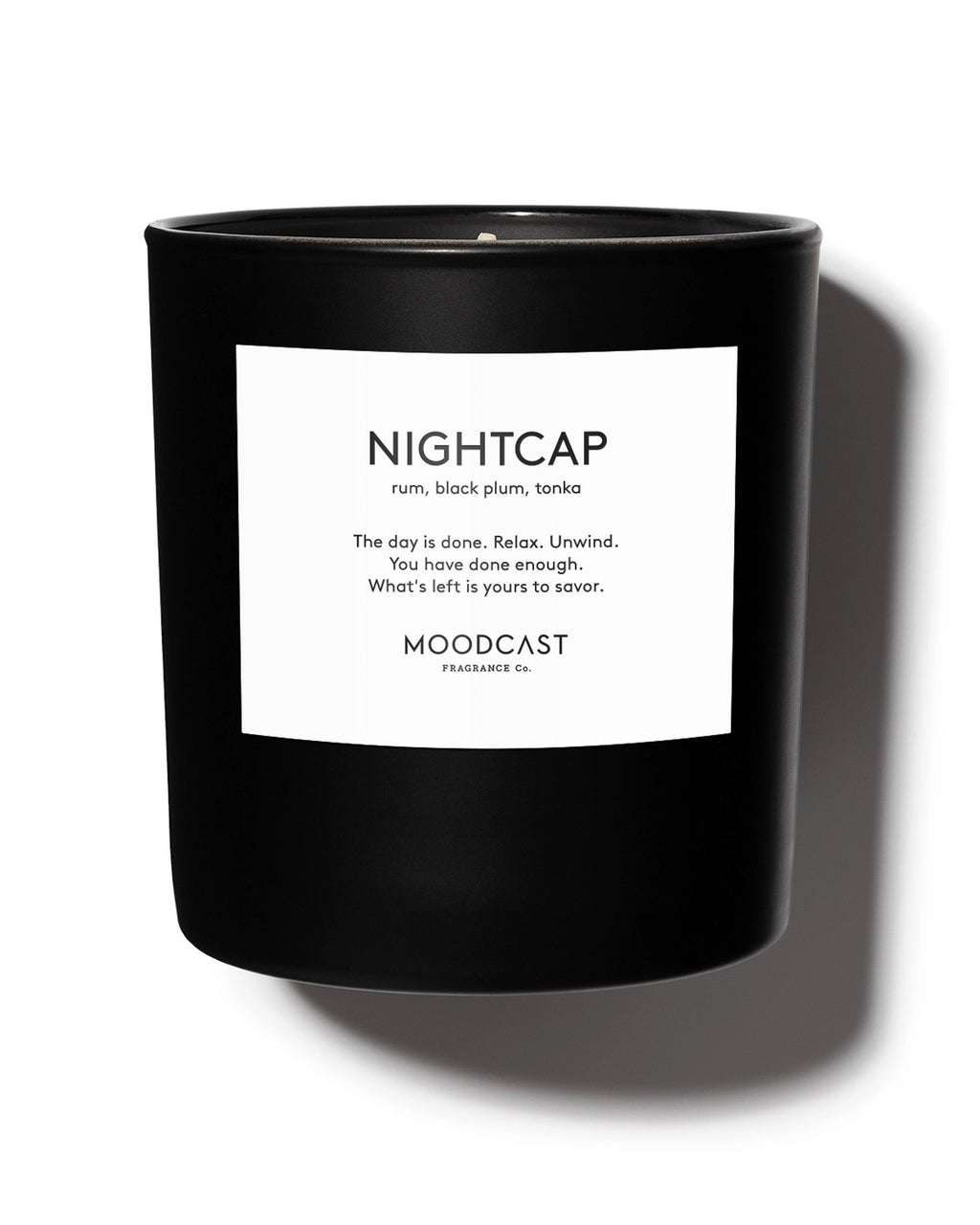 Luxury scented candle with notes of dark rum, black plum, tonka, bergamot, and orange blossom