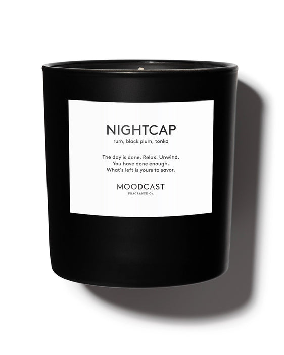 Luxury scented candle with notes of dark rum, black plum, tonka, bergamot, and orange blossom