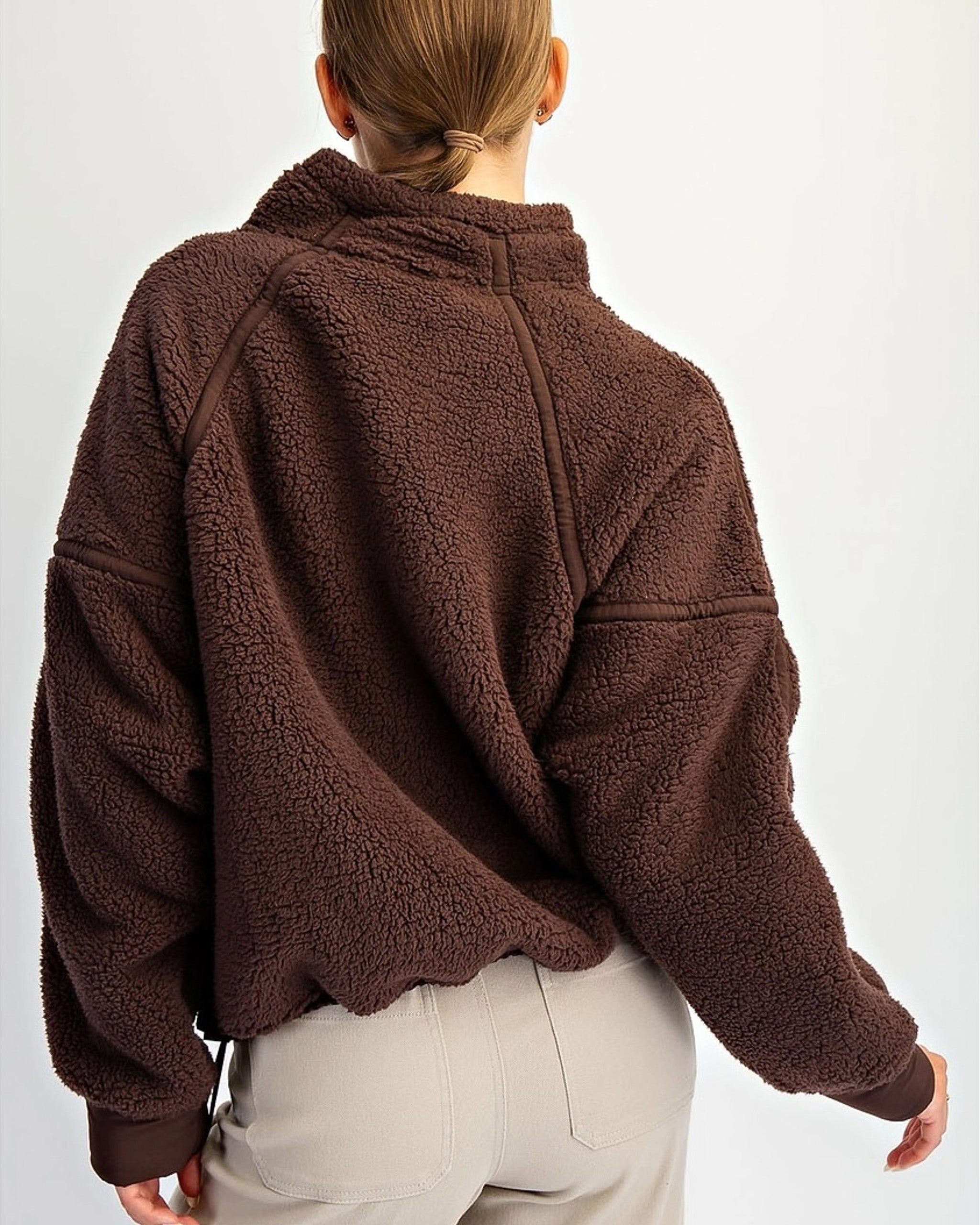 Cozy fleece pullover with adjustable hem and dropped shoulders. Women’s sherpa quarter zip for soft layering and effortless everyday wear.