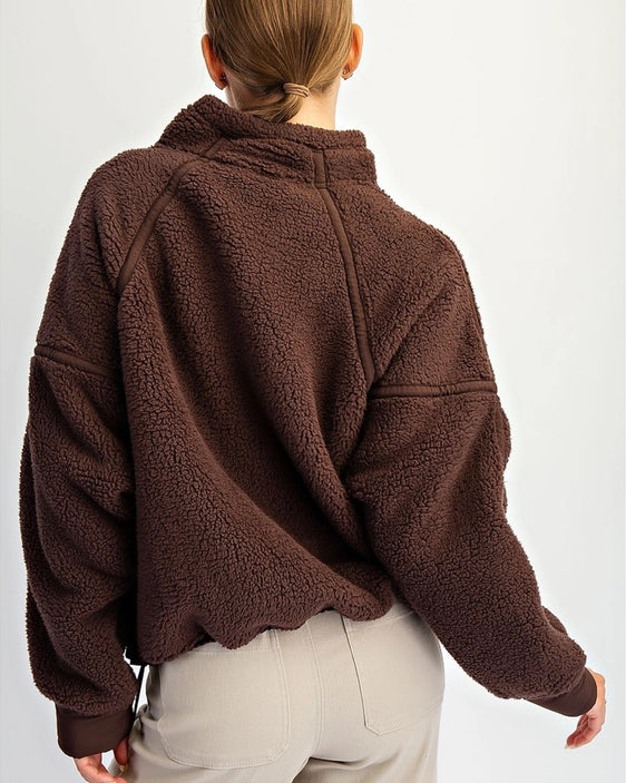 Cozy fleece pullover with adjustable hem and dropped shoulders. Women’s sherpa quarter zip for soft layering and effortless everyday wear.
