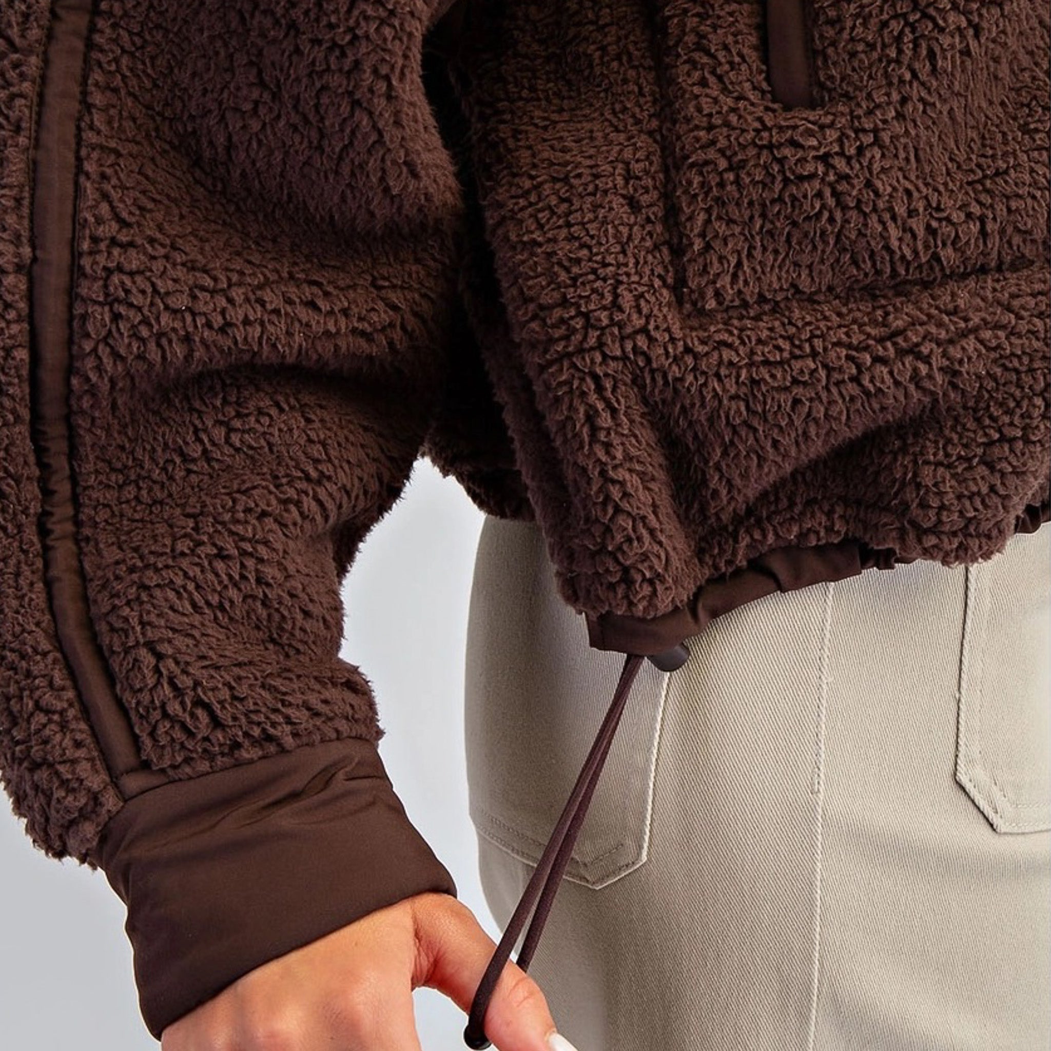 Women’s fleece quarter zip with plush sherpa softness, relaxed fit, and cinchable hem. Cozy, breathable, and perfect for everyday layering.
