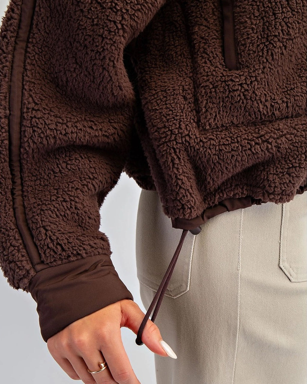 Women’s fleece quarter zip with plush sherpa softness, relaxed fit, and cinchable hem. Cozy, breathable, and perfect for everyday layering.