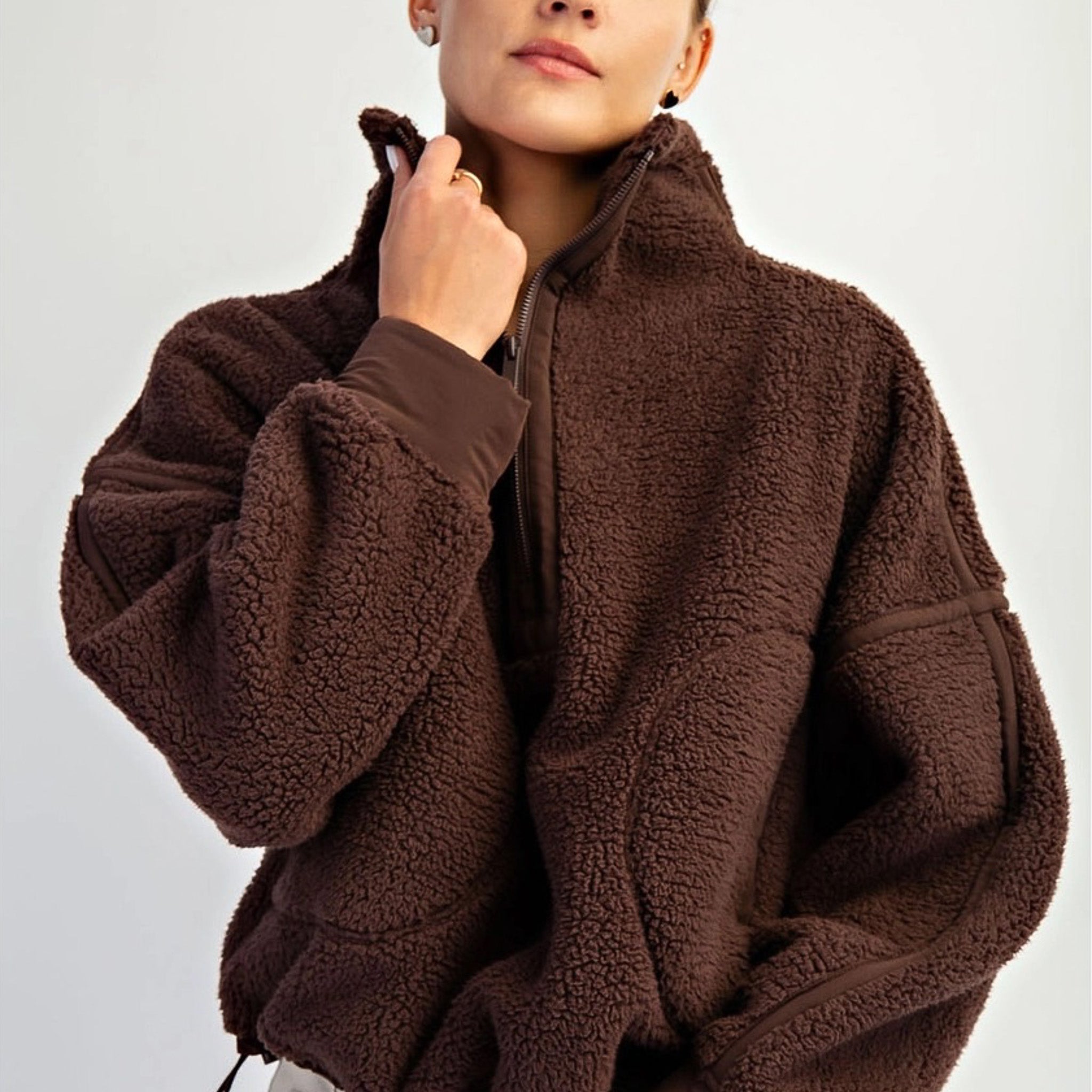 Women’s fleece quarter zip with plush sherpa softness, relaxed fit, and cinchable hem. Cozy, breathable, and perfect for everyday layering.