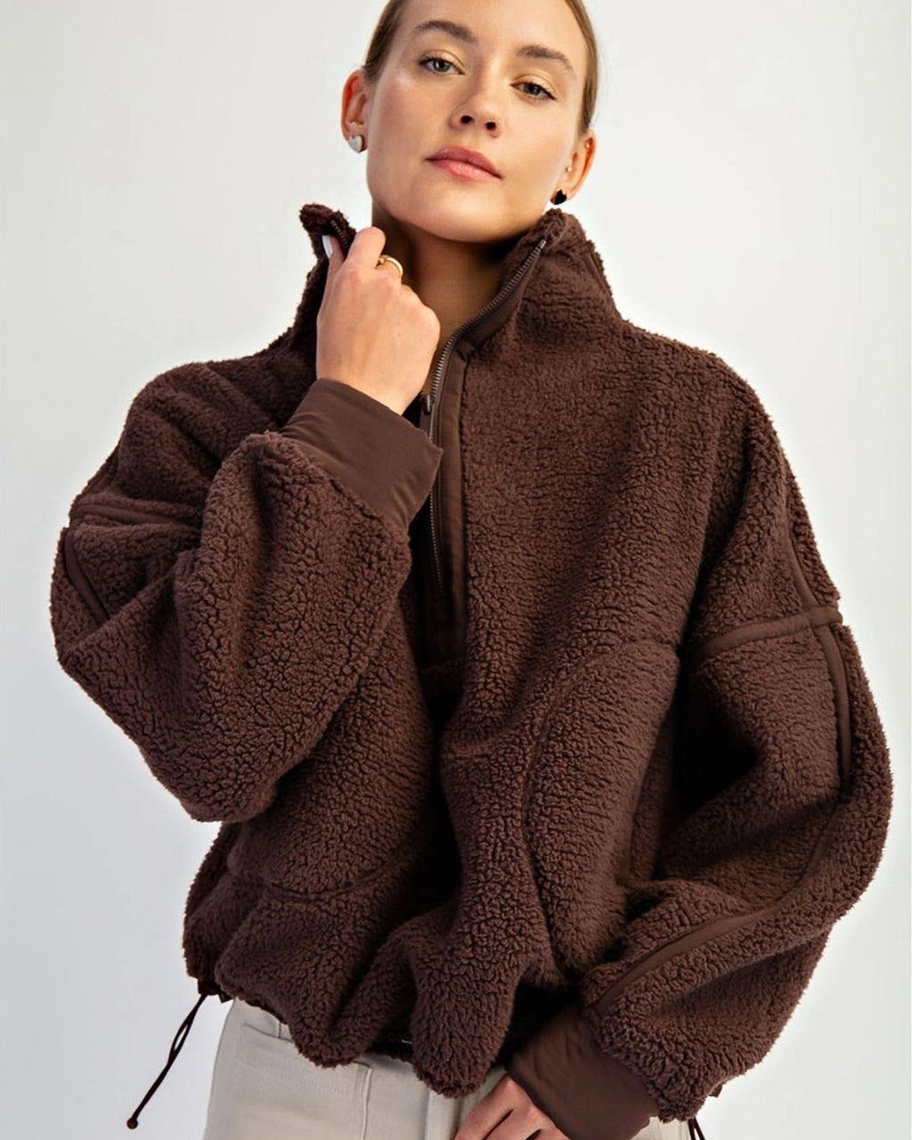 Women’s fleece quarter zip with plush sherpa softness, relaxed fit, and cinchable hem. Cozy, breathable, and perfect for everyday layering.