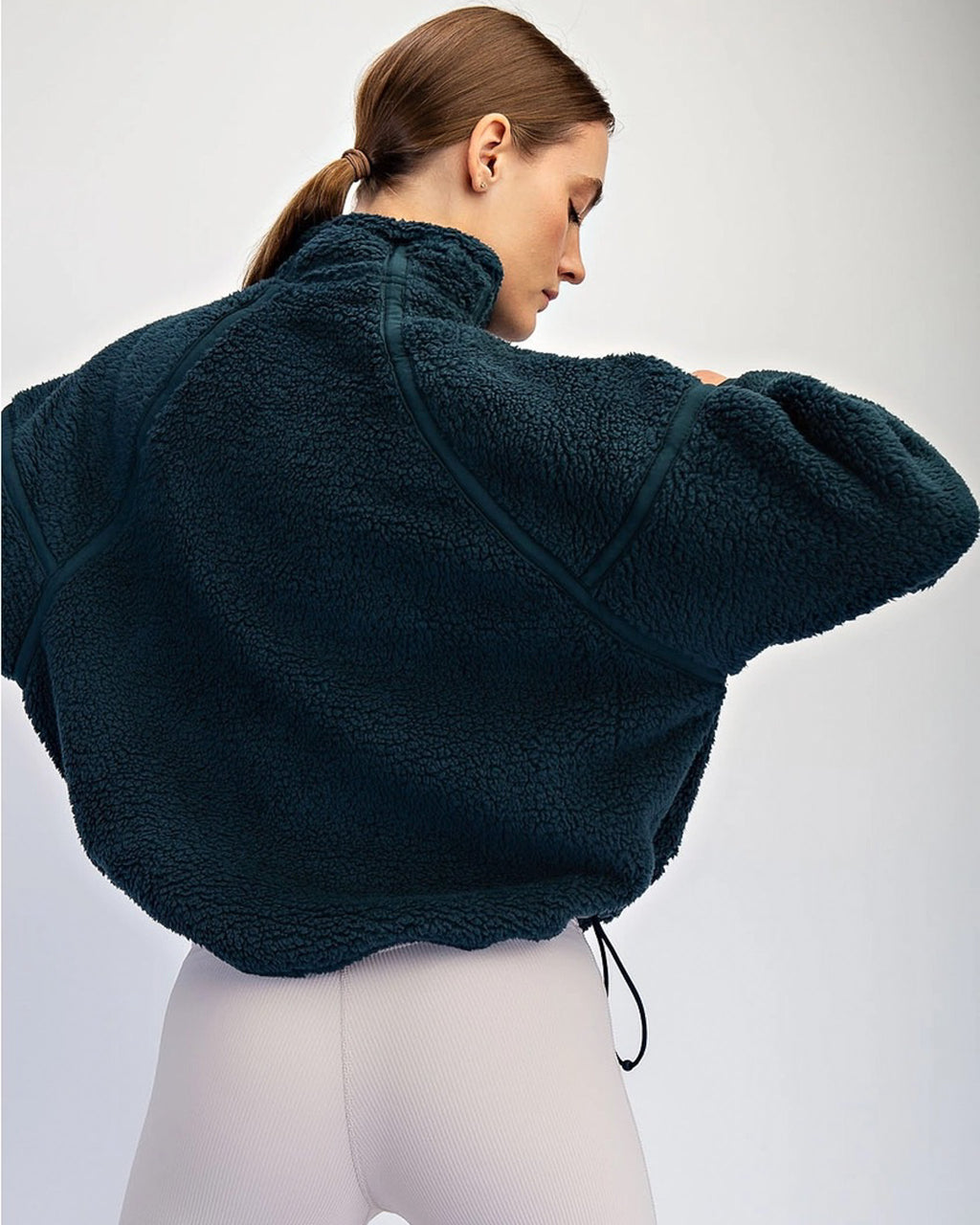 Sherpa quarter zip pullover with mock neck and side pockets. Lightweight fleece comfort for coffee runs, travel days, and chilly mornings.