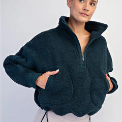 Women’s fleece quarter zip with plush sherpa softness, relaxed fit, and cinchable hem. Cozy, breathable, and perfect for everyday layering.