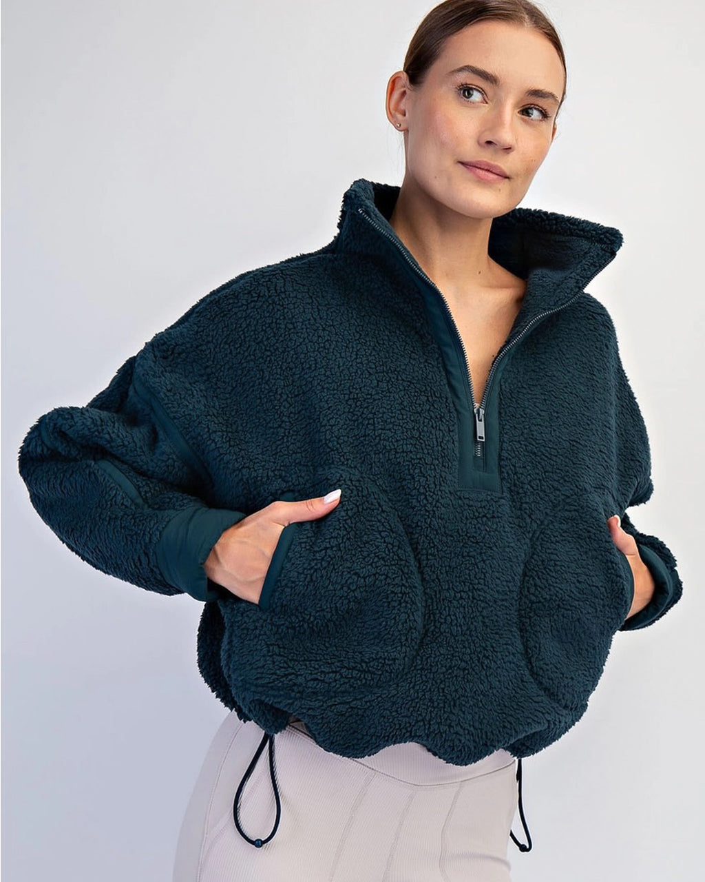 Women’s fleece quarter zip with plush sherpa softness, relaxed fit, and cinchable hem. Cozy, breathable, and perfect for everyday layering.