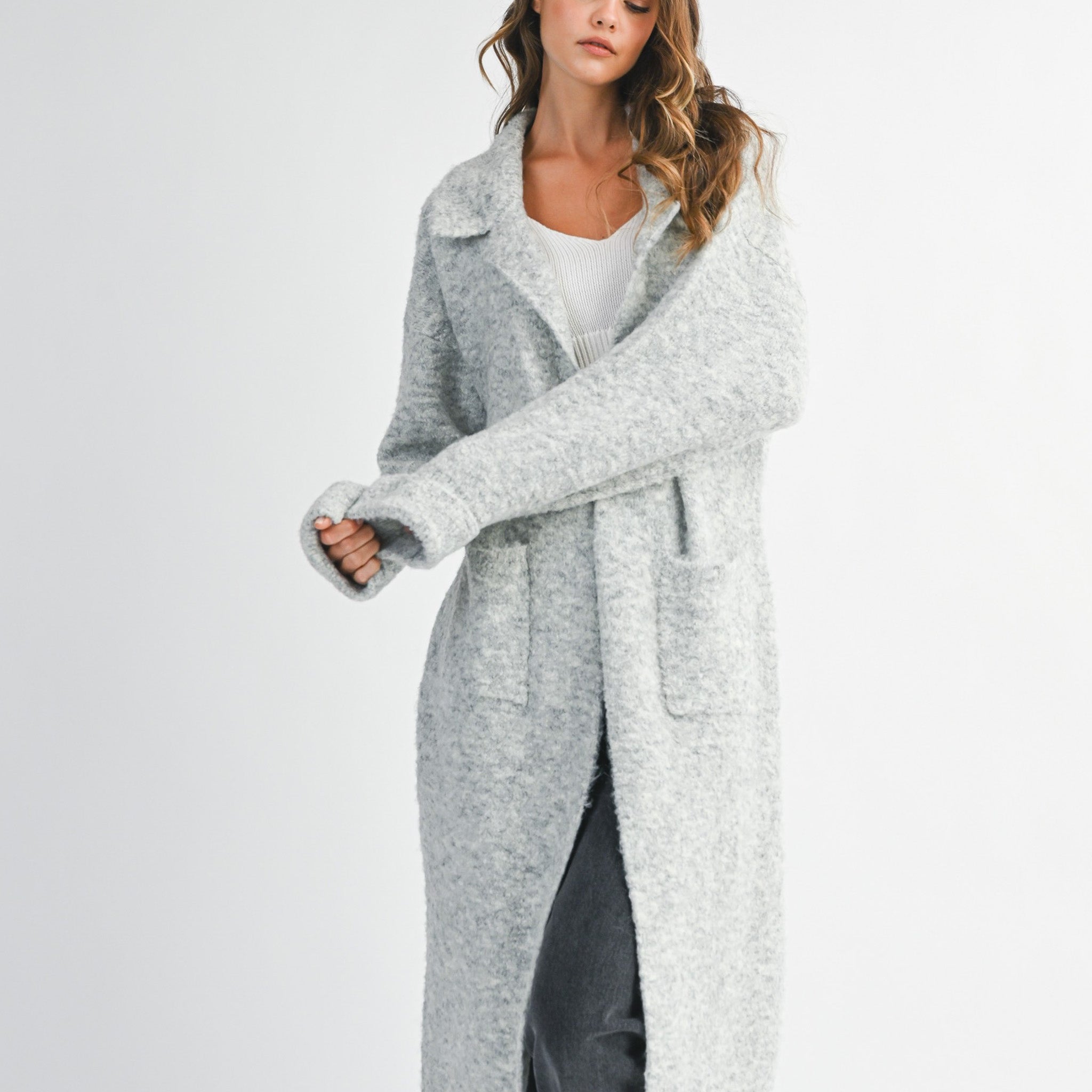 woman wearing long grey cardigan sweater with collared neckline