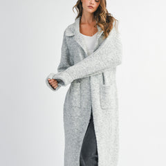 woman wearing long grey cardigan sweater with collared neckline