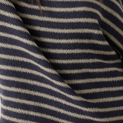 Close-up of a knit sweater with horizontal navy and gray stripes, showing the textured fabric and a small section of dark hair at the top.