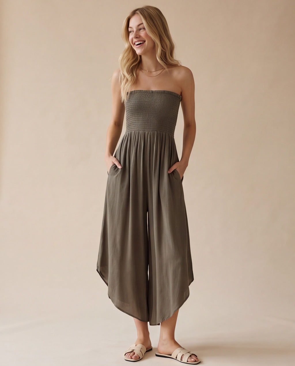 Blue smocked strapless wide-leg jumpsuit with pockets and flowy round hem detail