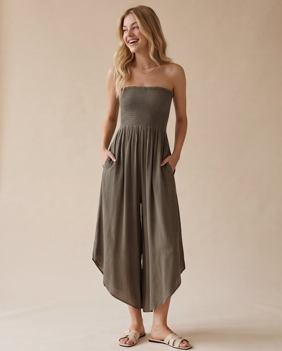 Blue smocked strapless wide-leg jumpsuit with pockets and flowy round hem detail