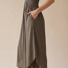 Blue smocked strapless wide-leg jumpsuit with pockets and flowy round hem detail