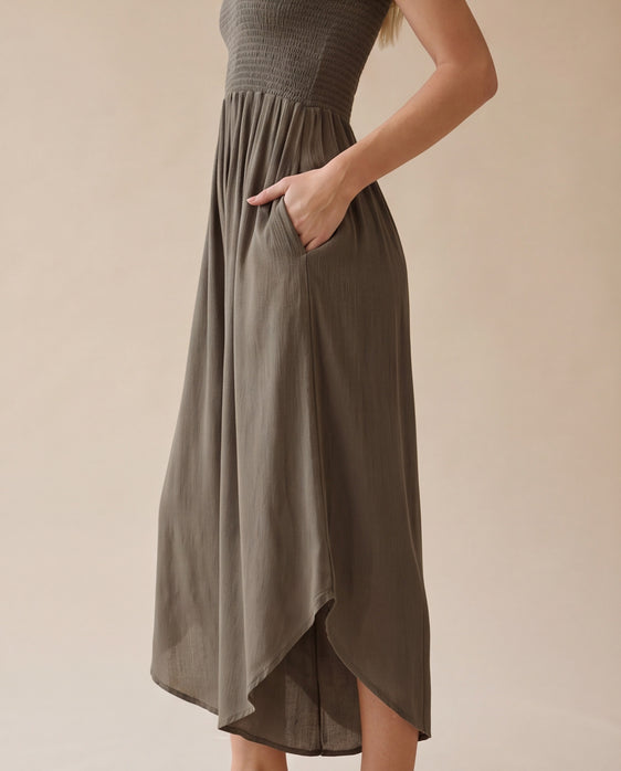 Blue smocked strapless wide-leg jumpsuit with pockets and flowy round hem detail