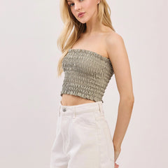 sage green smocked bandeau tube top with ruffle trim styled with denim shorts