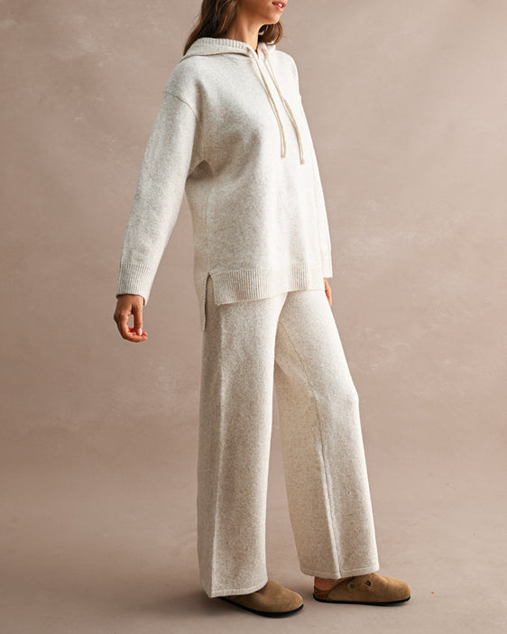 woman wearing cream wide leg knit pants and matching hooded knit sweater