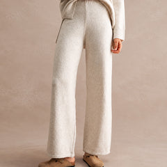 woman wearing wide leg knit pants and matching hooded sweater