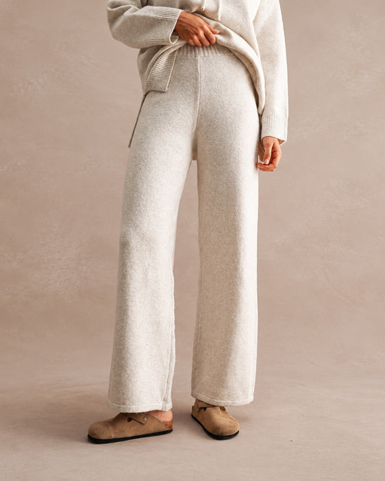 woman wearing wide leg knit pants and matching hooded sweater