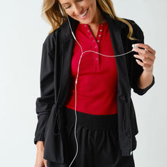 Women's lightweight black peplum active jacket with zip-up mock neck, adjustable waist, four-way stretch fabric, and relaxed athletic fit.